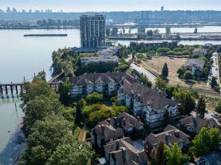 Discover waterfront living in this stunning property featuring a modern high-rise condo and charming townhouses.