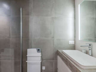 Experience modern bathroom design with sleek grey tiles and a minimalist aesthetic.