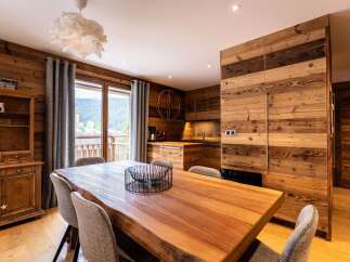 Experience rustic charm in this mountain retreat, featuring a spacious live-edge dining table perfect for family gatherings.