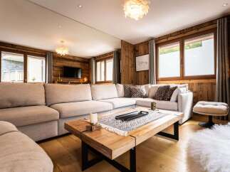 Experience rustic charm and modern comfort in this inviting living room, featuring a spacious sectional sofa perfect for relaxation.