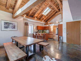 Experience rustic charm and modern convenience in this spacious open-plan living area.
