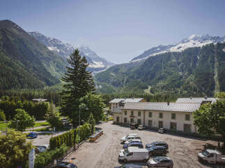 Experience breathtaking mountain views from this property, nestled amidst lush green forests and snow-capped peaks.