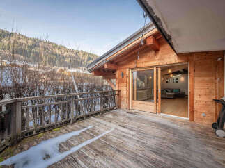 Enjoy stunning mountain views from this charming wooden chalet's expansive deck, perfect for outdoor entertaining.