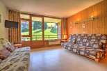 This cozy living room features a comfortable sofa bed with a charming heart pattern, perfect for relaxing after a day of outdoor adventures.