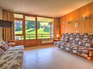 This cozy living room features a comfortable sofa bed with a charming heart pattern, perfect for relaxing after a day of outdoor adventures.
