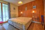 This charming bedroom features two comfortable beds adorned with a decorative throw, perfect for a cozy retreat.