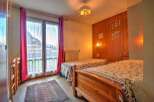 This charming bedroom features two comfortable twin beds, perfect for accommodating guests or family.