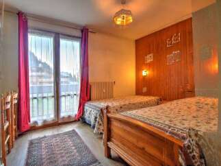 This charming bedroom features two comfortable twin beds, perfect for accommodating guests or family.