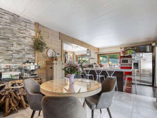 Experience the perfect blend of rustic charm and modern convenience in this inviting dining and kitchen area.