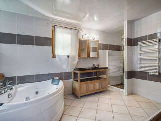 Indulge in relaxation in this luxurious bathroom featuring a spacious jacuzzi tub and a separate shower area.