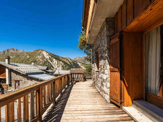 Experience breathtaking mountain views from this charming wooden balcony, perfect for enjoying your morning coffee or evening sunset.