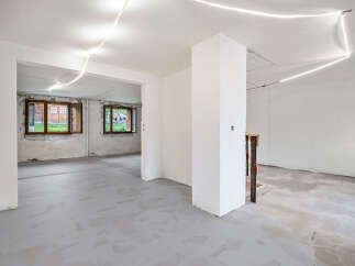 Discover the potential of this unfinished interior space, featuring a bright and airy atmosphere with smooth, light gray concrete floors.