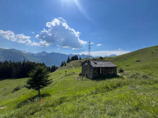 Discover this charming stone cabin nestled in a picturesque alpine meadow, offering breathtaking mountain views and a serene escape.