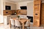Experience modern living in this beautifully appointed kitchen and dining area, featuring sleek cabinetry and integrated appliances.