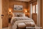 Experience rustic charm in this beautifully appointed bedroom, featuring warm wood-paneled walls and a cozy plaid throw.