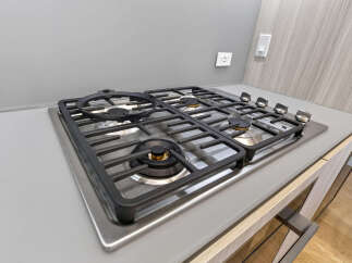 Experience modern culinary convenience with this sleek, built-in gas cooktop, featuring durable cast-iron grates and four powerful burners.