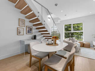 Experience modern living in this bright and airy space, featuring a sleek dining area with an oval table and comfortable chairs, perfect for intimate meals.