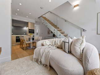 Experience modern living in this stunning open-concept space, featuring a sleek kitchen with integrated appliances and a chic dining area.