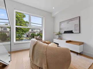 Experience modern living in this bright and airy living space, featuring a large window with scenic views and a stylish entertainment console.