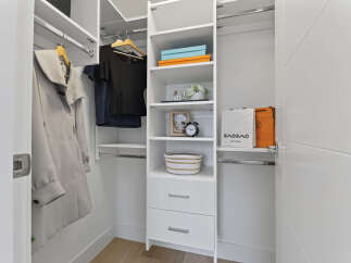 Discover organized luxury in this spacious walk-in closet, featuring ample shelving and hanging space for your wardrobe.