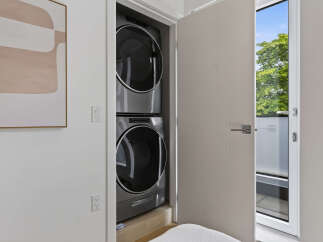 Discover modern convenience with this stacked washer and dryer unit, perfect for maximizing space in your home.