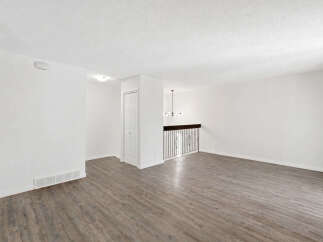 Step into this spacious and bright living area, featuring a modern open-concept layout perfect for entertaining.