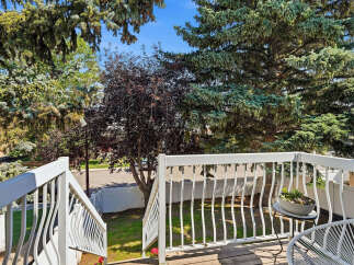 Enjoy outdoor living on this charming deck, perfect for relaxing or entertaining.