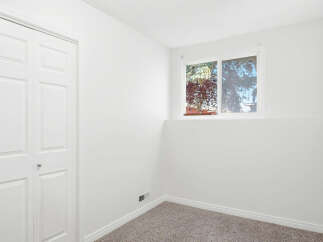 Discover comfort and style in this inviting room, featuring a spacious closet and a large window that floods the space with natural light.