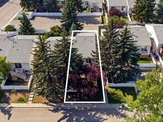 Discover this charming townhouse offering a private backyard oasis, perfect for relaxation and entertaining.