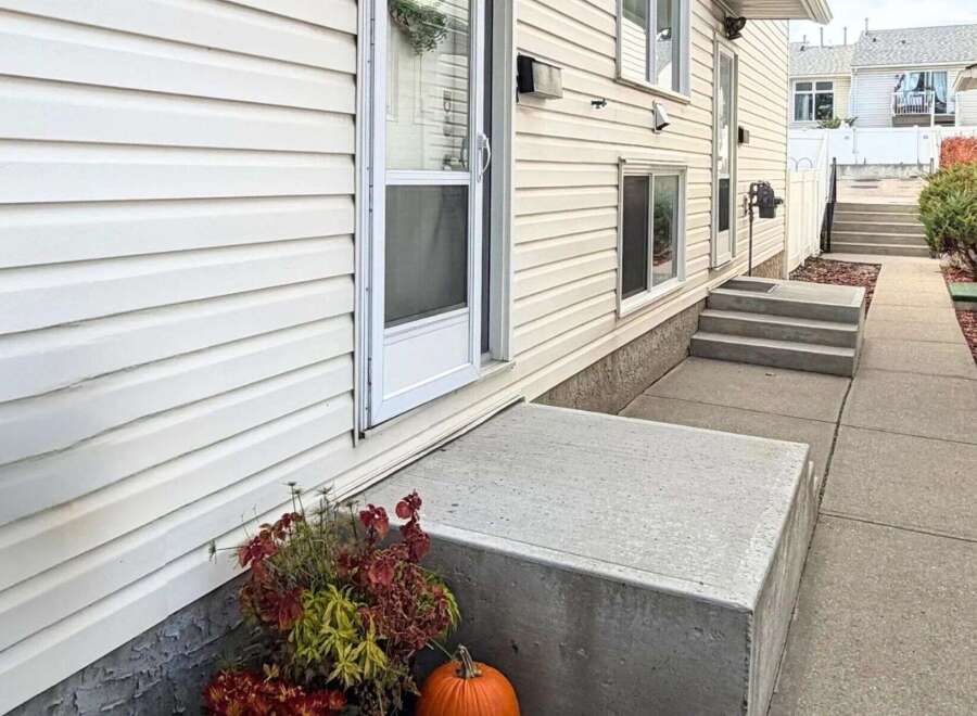Welcome to this charming home featuring a welcoming concrete porch and steps leading to the entrance.