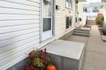 Welcome to this charming home featuring a welcoming concrete porch and steps leading to the entrance.
