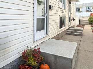 Welcome to this charming home featuring a welcoming concrete porch and steps leading to the entrance.