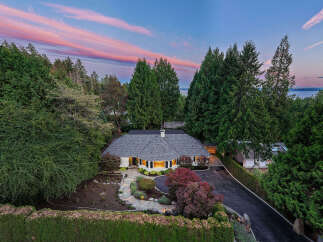 Experience twilight magic at this stunning residence, nestled amidst lush greenery and offering breathtaking sunset views.