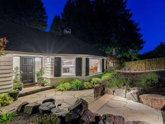 This charming home features a welcoming front entrance with a dark-paneled door and decorative shutters.