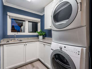 This laundry room features a convenient stacked washer and dryer set, perfect for maximizing space.