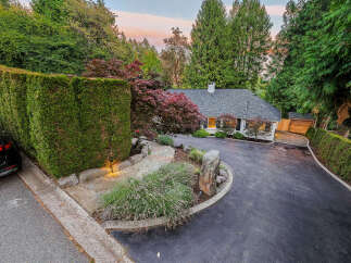 Nestled amidst lush greenery, this charming home offers a serene retreat with its meticulously landscaped grounds.