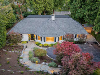 Discover this charming single-story home featuring a welcoming stone pathway leading to the entrance.