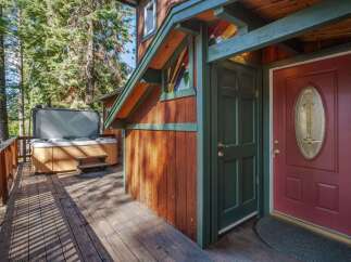 Relax and unwind in your private hot tub, nestled on a spacious wooden deck surrounded by towering trees.