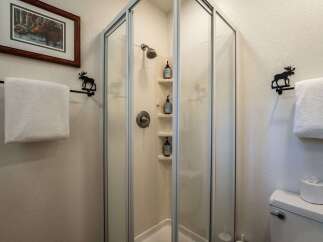 This bathroom features a charming moose-themed decor, including a framed print of a moose and decorative towel racks.