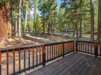 Enjoy the serene mountain setting from this charming wooden deck, perfect for outdoor relaxation.