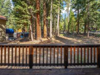 Enjoy the serene mountain lifestyle from this charming property, nestled amongst towering pine trees.