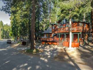 Nestled amidst towering pine trees, this charming multi-level home offers a serene mountain retreat.