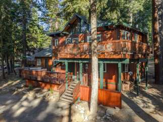 Nestled amidst tall pine trees, this charming wooden cabin offers a serene mountain retreat.