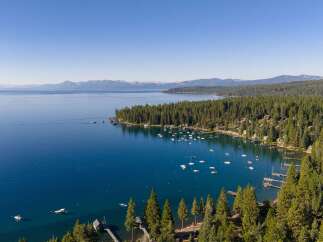 Experience luxury living with this stunning aerial view of a lakeside estate.