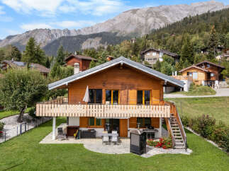 Experience alpine living in this charming wooden chalet, nestled amidst breathtaking mountain scenery.