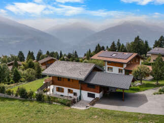 Discover this charming Swiss chalet-style home nestled in a serene mountain landscape.