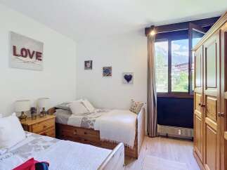 This charming bedroom features two twin beds, perfect for accommodating guests or family.