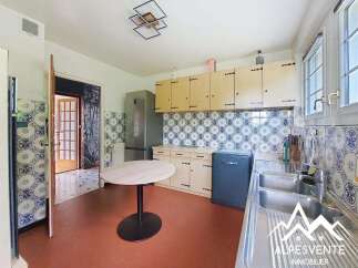 Discover this charming kitchen featuring a classic tiled backsplash and light wood cabinetry, offering ample storage.