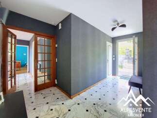 Step into a welcoming entryway featuring elegant marble flooring with a striking black and white pattern.