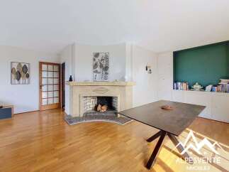 Discover this charming living room featuring a beautiful stone fireplace, perfect for cozy evenings.